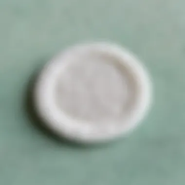 Gentle Cleanser on Cotton Pad A close-up view of a cotton pad soaked in a gentle cleanser, ready for makeup removal.