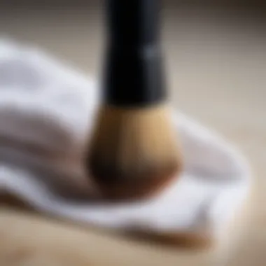 A clean makeup brush resting on a soft towel.